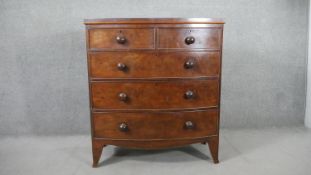 A Victorian mahogany bow front chest of two short over three long cockbeaded drawers, on bracket