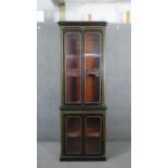 A Victorian Aesthetic movement ebonised bookcase, with a moulded cornice, over two glazed cupboard