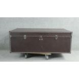 A Dentro Vittoria Steamer Trunk, upholstered in studded chocolate brown leather and having two