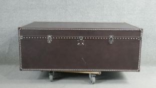 A Dentro Vittoria Steamer Trunk, upholstered in studded chocolate brown leather and having two