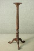 A Victorian mahogany torchere, with a circular top, on a rope twist and foliate carved stem, on