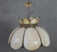 A Tiffany style stained glass pendant light, the shade of flowerhead form, with beaded metal borders