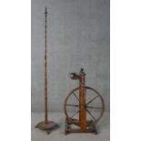 A 19th century spinning wheel in turned beech along with a wool spinners stand. H.178cm (largest)