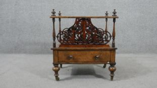 A Victorian figured walnut Canterbury, with ornately pierced dividers, over a single drawer with