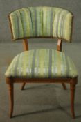 A Regency style beech chair, with a curved back, upholstered in striped fabric to the back and seat,