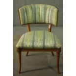 A Regency style beech chair, with a curved back, upholstered in striped fabric to the back and seat,