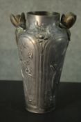 An Art Nouveau French pewter vase with waterlily handles (one damaged) and floral and foliate relief