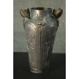 An Art Nouveau French pewter vase with waterlily handles (one damaged) and floral and foliate relief