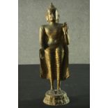 A brass Eastern standing Buddha figure. H.51cm.