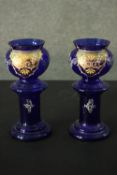 A pair of early 20th century Bohemian Bristol blue glass vases with gilded and enamel foliate and