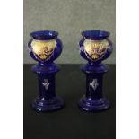 A pair of early 20th century Bohemian Bristol blue glass vases with gilded and enamel foliate and