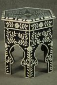 A contemporary Middle Eastern style hexagonal occasional table, ebonised wood inlaid with foliate