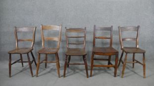A harlequin set of five 19th century kitchen chairs, with bar backs, four with saddle seats on