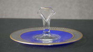 An Art Deco hand painted royal blue and gilded cut crystal cake stand with carrying handle.