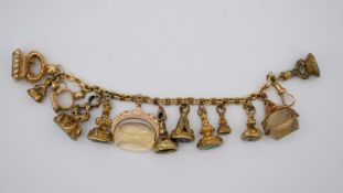A floral engraved rolled gold curb link fob bracelet with 9 carat yellow gold Albert clasp. Attached