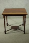 An Edwardian walnut occasional table, with a square top, on turned legs joined by X stretchers and