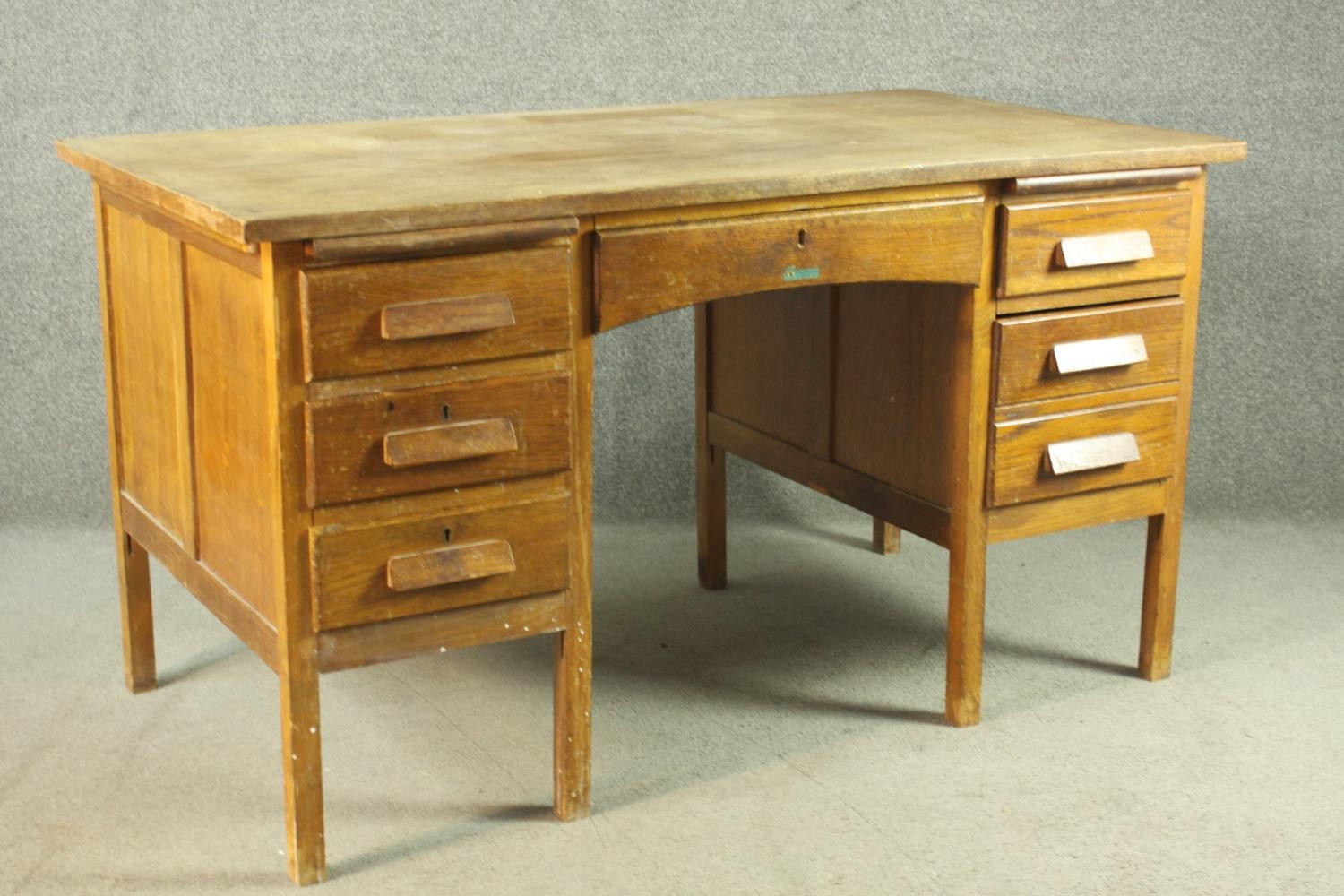 A circa 1940s oak desk, the rectangular top over two slides, and an arrangement of seven drawers - Image 3 of 8