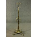 A 19th century brass extending standard stand for an oil lamp on scrolling tripod base. H.190cm (