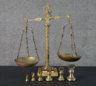 A set of Victorian brass shop scales with weights. Mounted on a marble base and with lion head