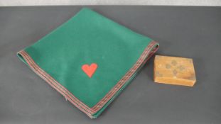 A baize card playing table mat and boxed cards.