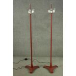 A pair of vintage floor standing cast metal three branch standard lamps each with three conical