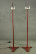 A pair of vintage floor standing cast metal three branch standard lamps each with three conical