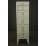 A 20th century white painted steel filing cabinet, with fifteen drawers, on tapering backet legs.