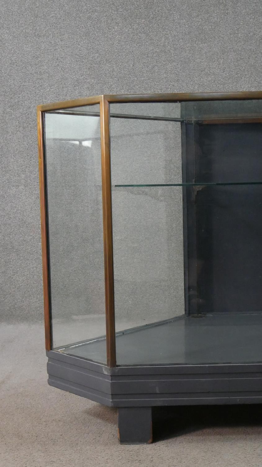 A mid 20th century shop corner display cabinet, glazed, with brass edges, enclosing a single - Image 2 of 7