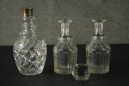 Three cut crystal decanters, one with a silver collar, a pair Georgian and one faceted glass