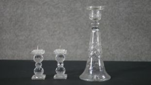 A pair of Swarovski crystal candlesticks along with a blown glass conical design candlestick. H.22