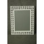A white painted woven rattan framed mirror, with a rectangular mirror plate. H.53 W.43cm.