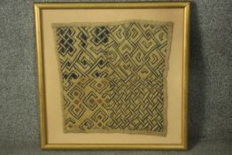 A Kuba raffia woven cloth, Congo, formed of four geometric panels, framed. H.57 W.57cm.