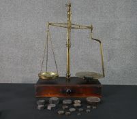 A set of 19th century brass and mahogany weighing scales with a selection of brass and cast iron