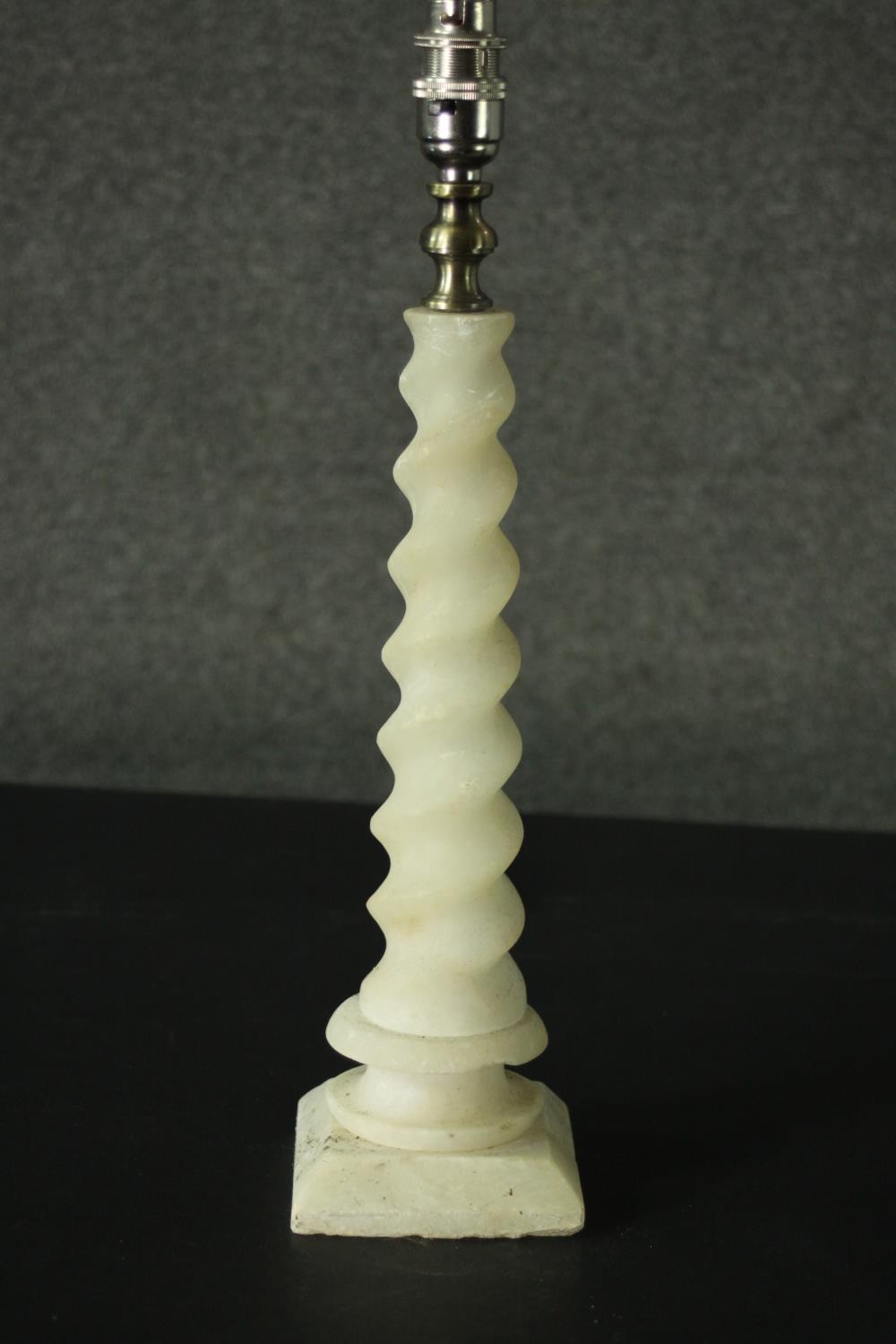 An alabaster table lamp, with a barley twist stem, on a square section base. H.42cm.