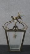 A 20th century George III style cast metal hall lantern, with a scrolling top over four tapering