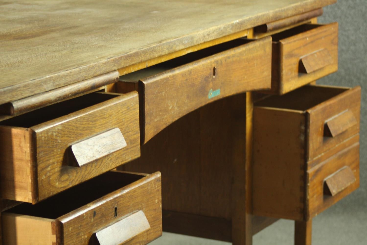 A circa 1940s oak desk, the rectangular top over two slides, and an arrangement of seven drawers - Image 6 of 8