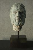 A bronze effect resin and concrete mask of a bearded man on a display stand. H.70cm. (mask)