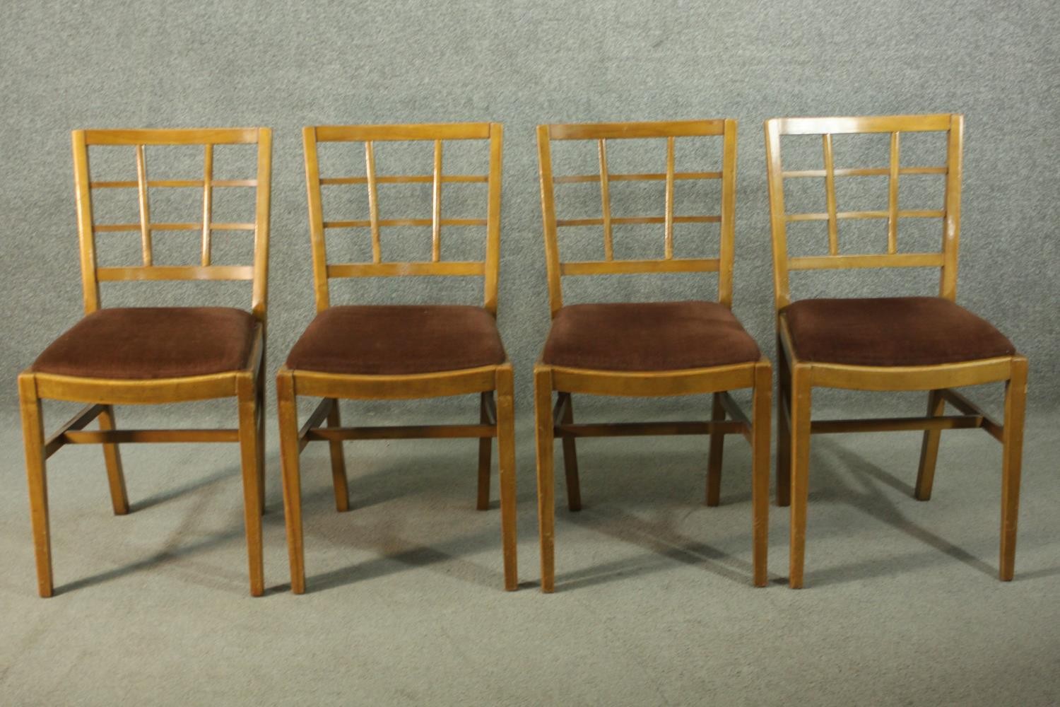A set of vintage Heal's style dining chairs, with lattice backs, over a brown velour drop in seat,