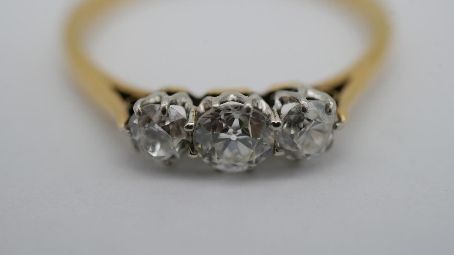 A 18 carat yellow gold and platinum three stone diamond ring, set with three round old cut - Image 3 of 7