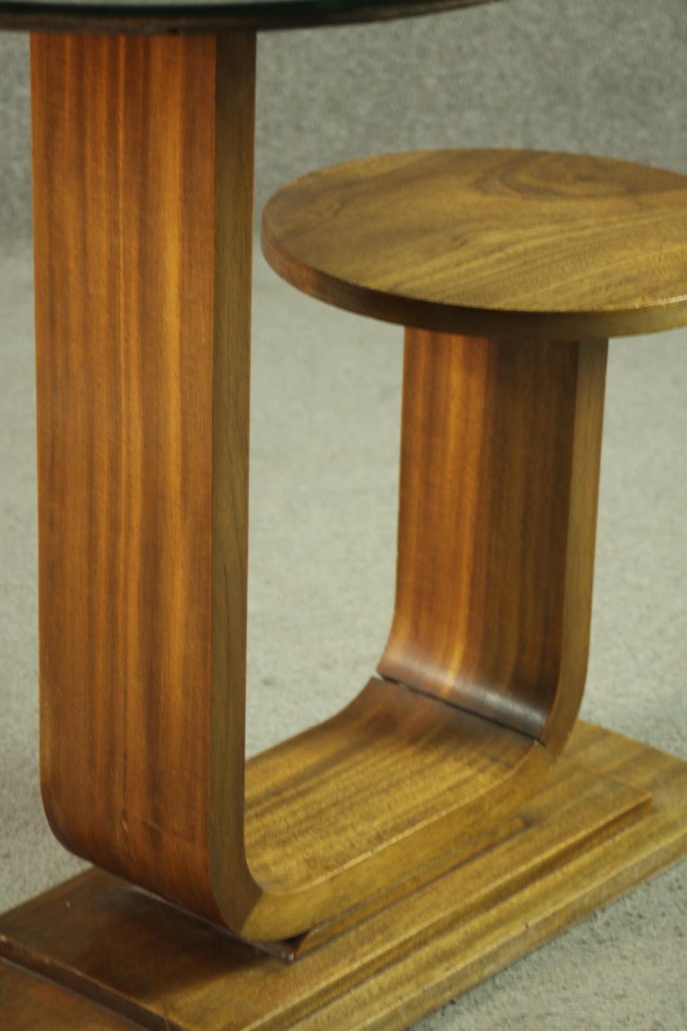 An Art Deco teak table and stool, with a circular glass table top, on a support which curves up to a - Image 6 of 8