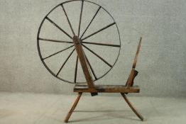 A rustic spinning wheel, possibly Welsh. H.146 W.124 D.43cm. (Wheel: 100cm)