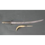 A carved spiral handled sword with brass finial and steel blade along with a horn handled dagger.