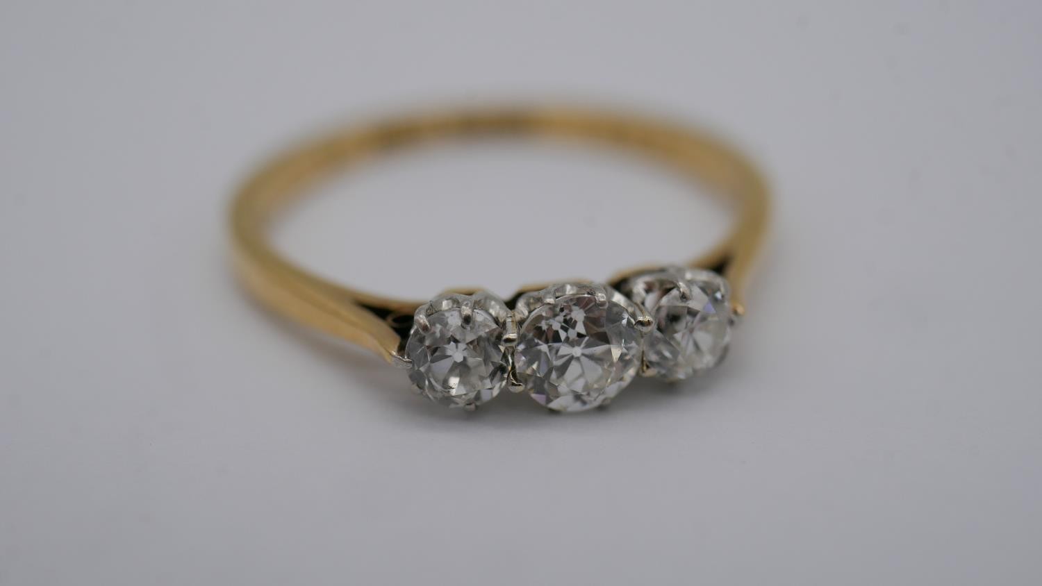 A 18 carat yellow gold and platinum three stone diamond ring, set with three round old cut - Image 2 of 7