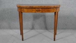 A Sheraton design mahogany card table of D form, the foldover top crossbanded in satinwood,