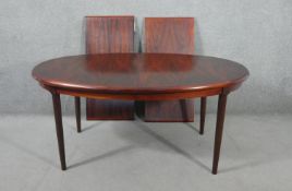 A vintage extending dining table with two extra leaves on tapering shaped supports. H.70 W.260 W.
