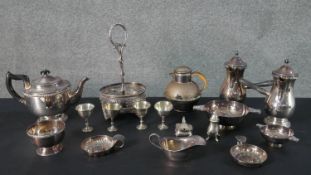 A large collection of silver plate, including a pair of cafe au lait pots, egg cups, sugar bowl,