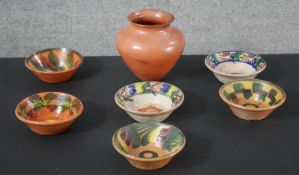 A collection of six Continental glazed terracotta bowls with various designs along with a large