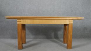 A contemporary birch extending dining table, with a rectangular top on square section legs. H.75 W.