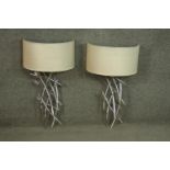 A pair of nickel plated abstract design wall lights by R.V.A. Lighting with cream semicircular