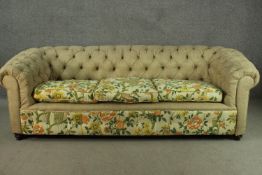 A Chesterfield three seater sofa, with a button back, upholstered in oatmeal fabric, the cushions